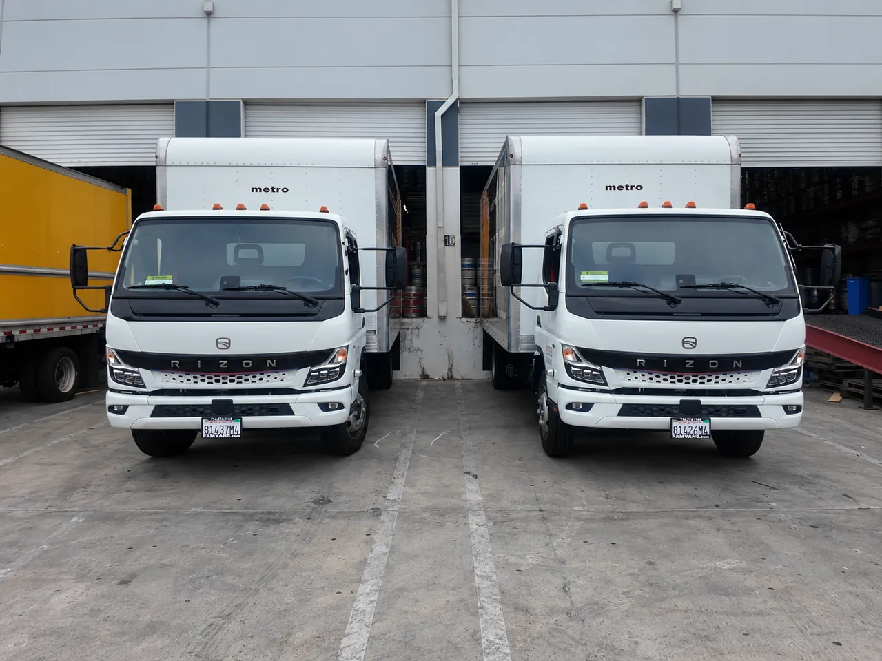 Two Brown Bag Beverage RIZON electric trucks at the loading docks
