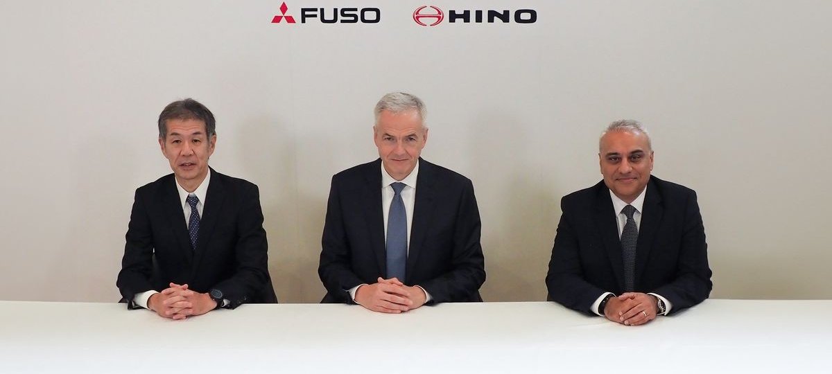 Mitsubishi Fuso, Daimler Truck and Hino executives at the integration press conference in front of an ARCHION, FUSO and HINO backdrop