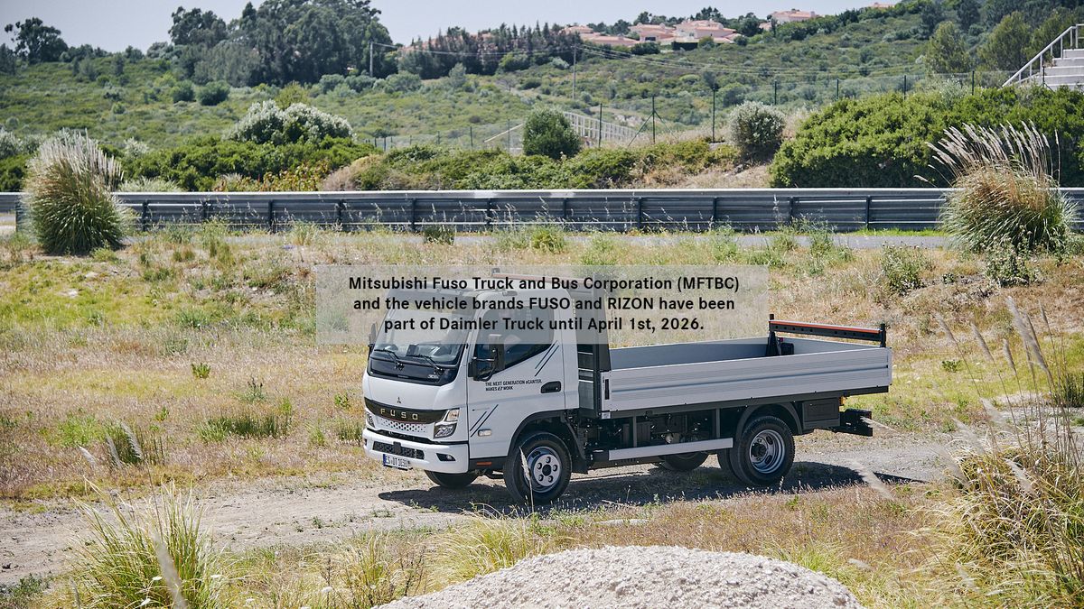 Next Generation FUSO eCanter all-electric flatbed truck standing on a gravel area beside a test track in Portugal